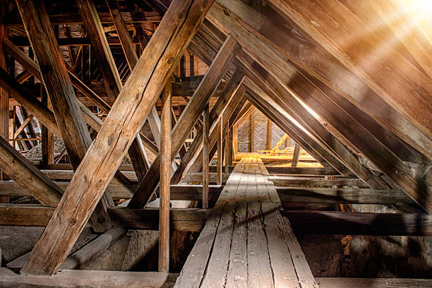 Rafters and beams in a dusty old attic.