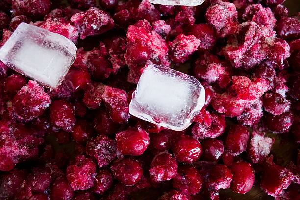 istock Frozen  red cherries and pieces of ice 511112936