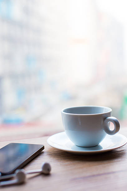 Mobile phone with coffee on a wooden table