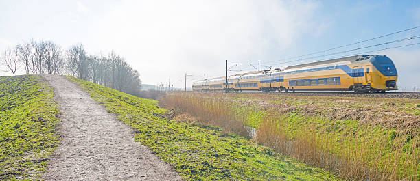 istock Electric train riding through foggy nature 511115600