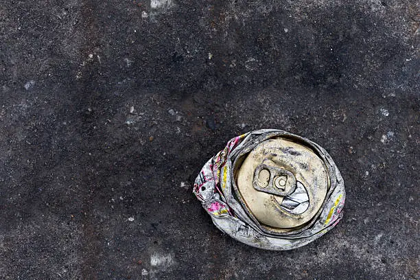 crushed can on the road