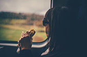 Woman on train eating a sandwich