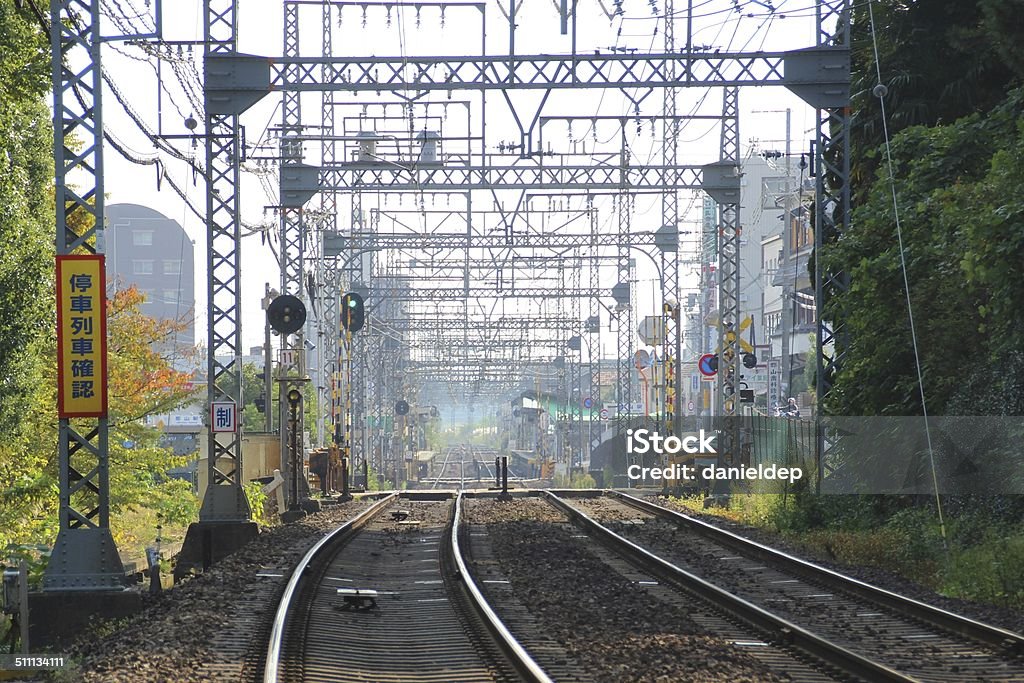 Japanese Trains Tracks Looking down the tangle mess of metal of train tracks of a suburban train line in Nara, Japan Railroad Track Stock Photo