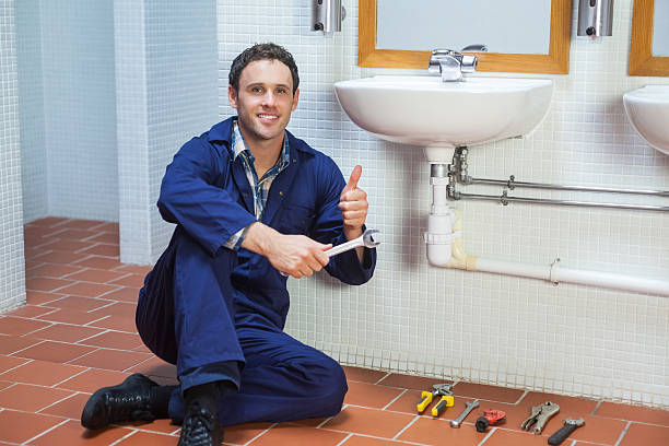 istock Handsome happy plumber sitting next to sink showing thumb up 511134221