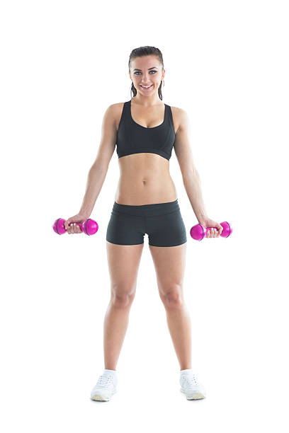 istock Slender brunette woman using dumbbells for training her arms 511134643