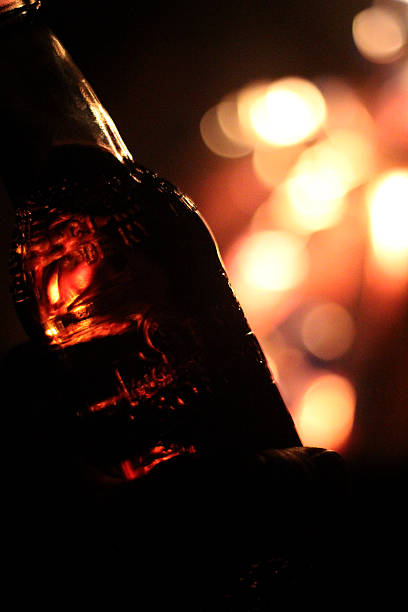 Glass Bottle and Campfire stock photo