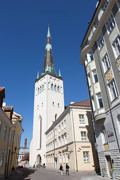 Tallinn, Estonia - May 17, 2014: Tallinn is the capital of Estonia.Tallinn's Old Town is listed as a UNESCO World Heritage Site. The picture shows St. Olaf's Church. People - mostly tourists - walking the streets through the old town.