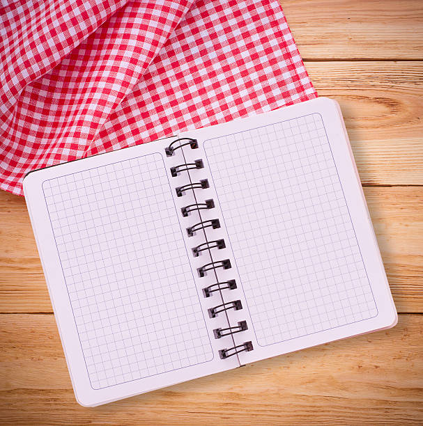 istock Pure notebook for recording menu, recipe on tablecloth tartan. 511139361