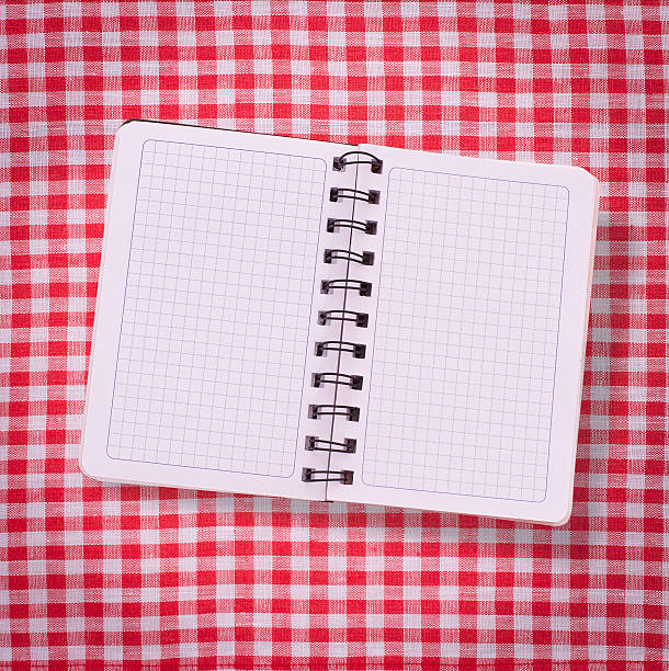 istock Pure notebook for recording menu, recipe on tablecloth tartan. 511139381