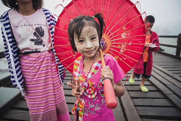 Asian kids with art painted with powde in Sangkhlaburi.  Kanchanaburi,Thailand-December 12, 2015: Asian kids with art painted with powder on Mon village and the longest wooden bridge in Sangkhlaburi, Thailand. sangkhla stock pictures, royalty-free photos & images