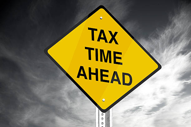 Tax Time Ahead 'Tax Time Ahead' road sign. IRS Headquarters Building stock pictures, royalty-free photos & images