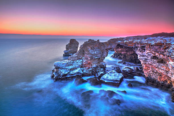 istock Sunrise over the sea and stone arch 511191304