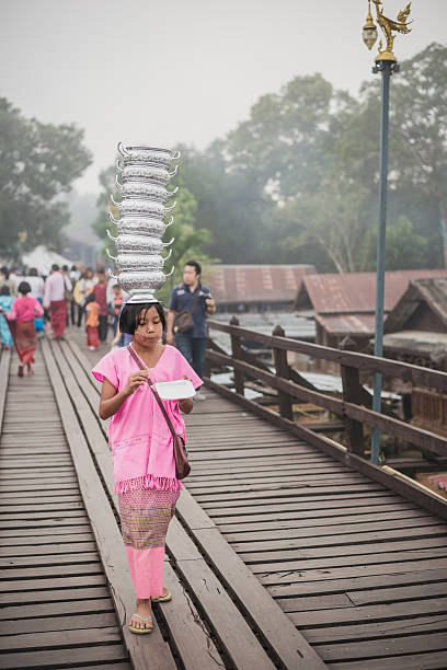 Asian kids with art painted with powde in Sangkhlaburi.  Kanchanaburi,Thailand-December 12, 2015: Asian kids with art painted with powder on Mon village and the longest wooden bridge in Sangkhlaburi, Thailand. sangkhla stock pictures, royalty-free photos & images