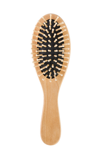 Close up wooden comb isolated on white background.