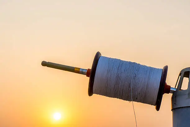 Photo of Indian kite spool at sunset