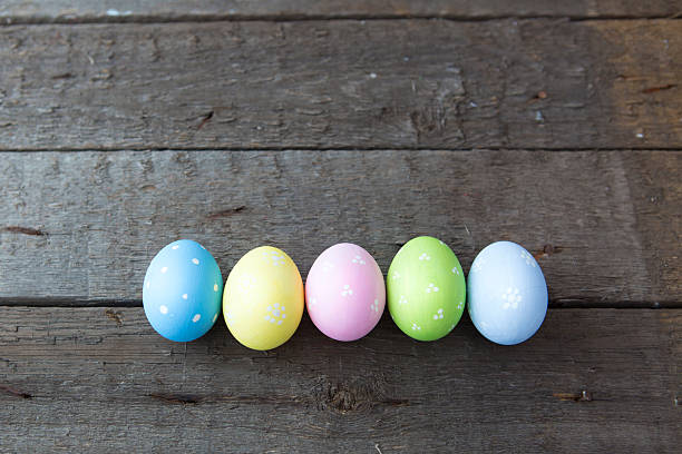 istock Colorful Easter eggs decoration line over wood 511195608