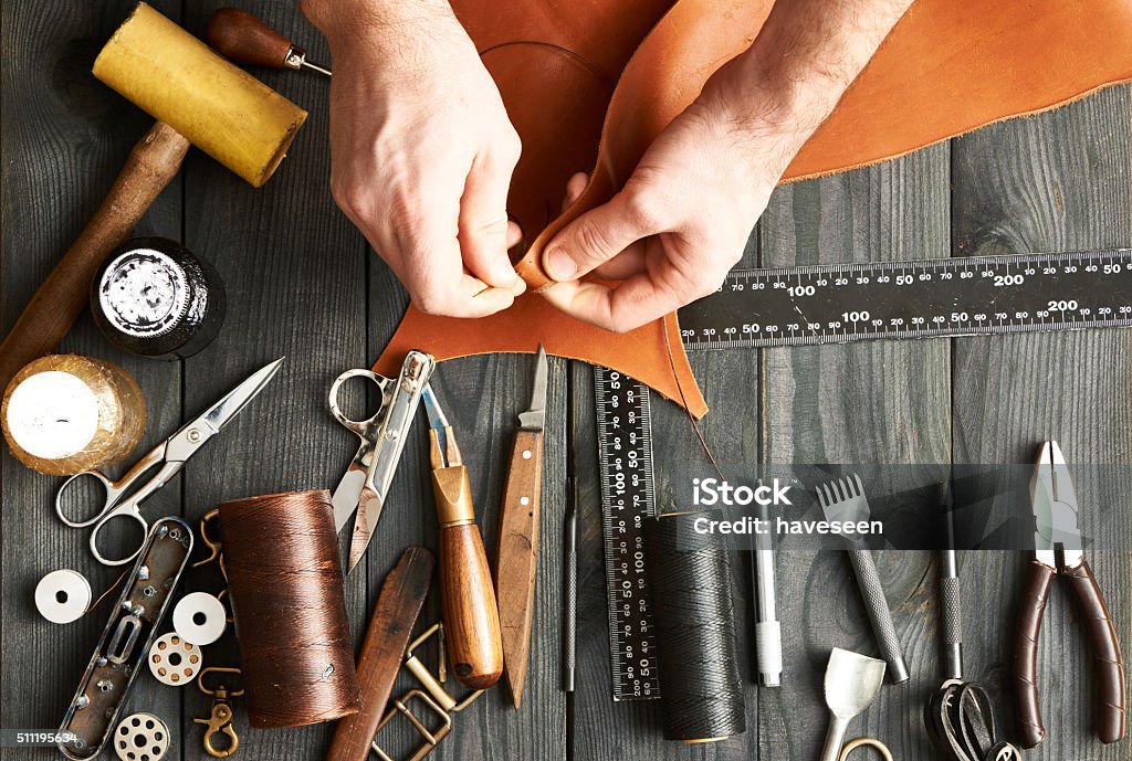 Man working with leather Man working with leather using crafting DIY tools Leather Stock Photo