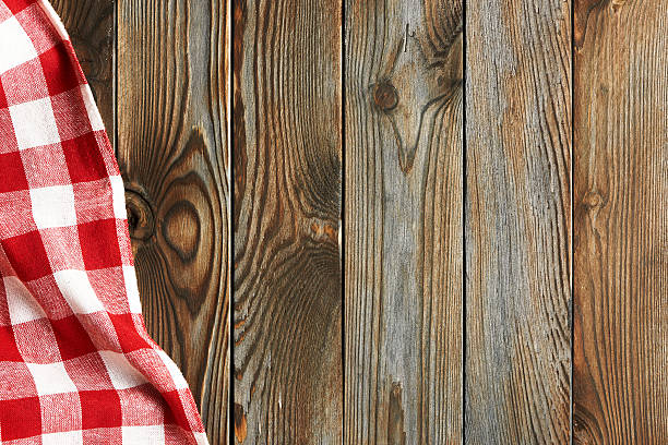 istock Textured wooden background with red tablecloth 511197336