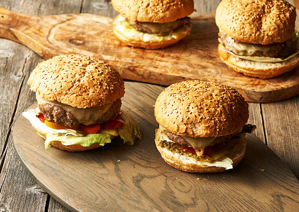 istock Home made cheeseburgers on wooden table 511199220