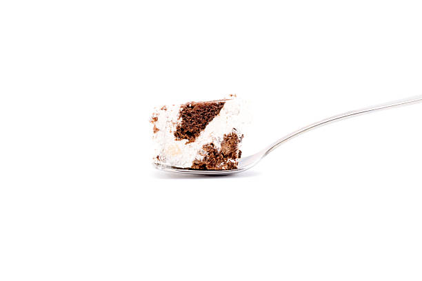istock Piece of cake on a spoon isolated 511199808