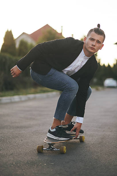 istock Image of a man with longboard going on road 511200528