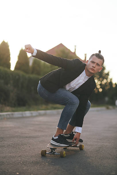 istock Image of a man with longboard going on road 511200550