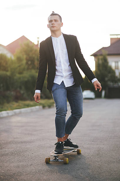 istock Image of a man with longboard going on road 511200634