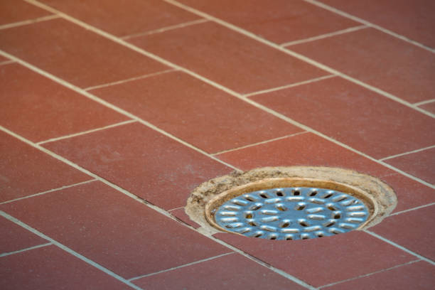 Locker room tiled floor with drain.