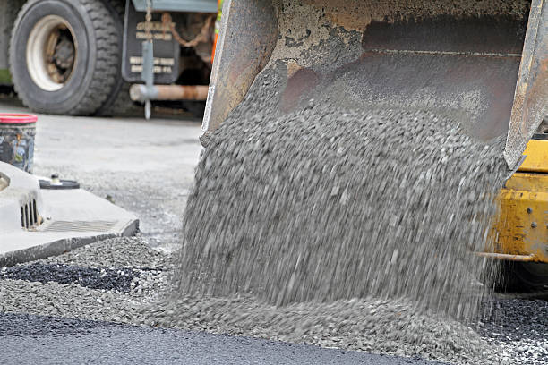 istock Mini Front End Loader Dumping Gravel On Road Repair Site 511203038
