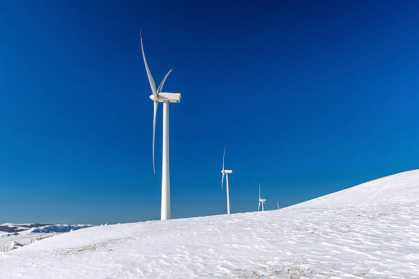 istock Wind turbine and blue sky in winter landscape. 511204322