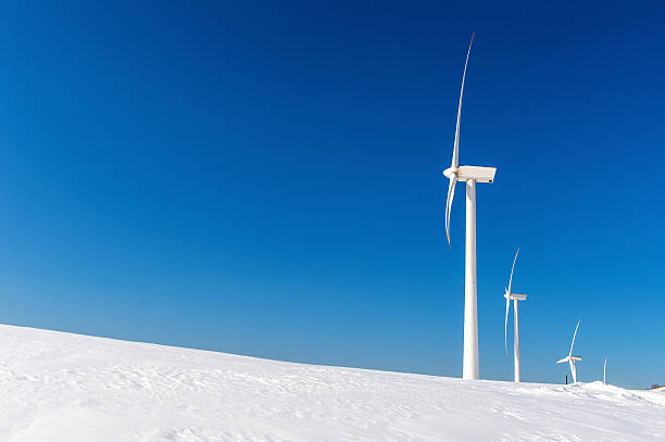Snow and fog at a rural windfarm in Scotland during harsh December weather.