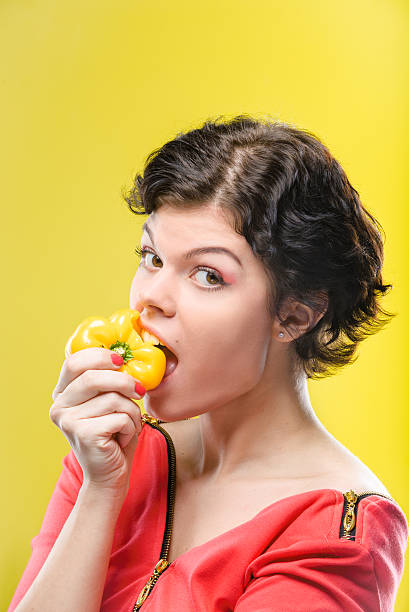 istock Girl with yellow sweet pepper 511207364