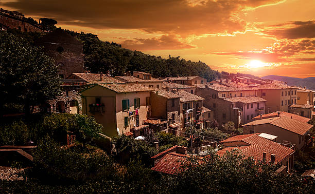 Sunset over tuscan Costona town Golden sunset over tuscan Costona town, Italy cortona stock pictures, royalty-free photos & images