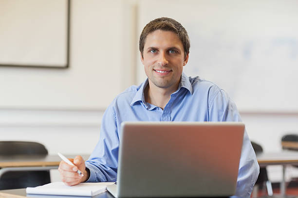 istock Handsome mature student learning and sitting in classroom 511210787