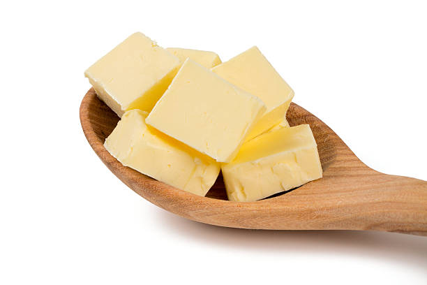 istock fresh butter in a wooden spoon 511210814