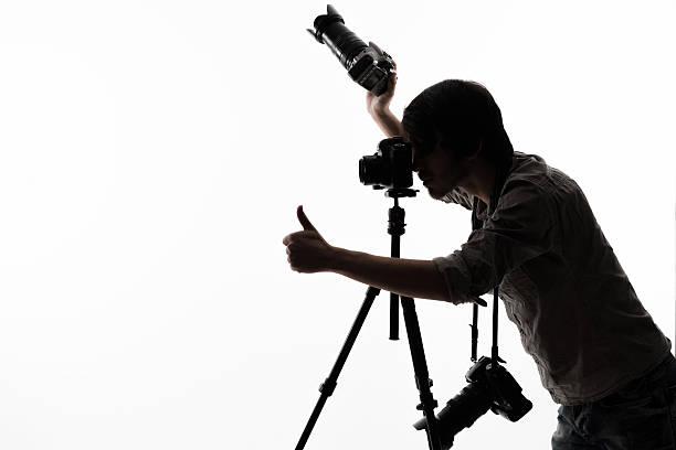 istock Photographer with camera and tripod 511211864