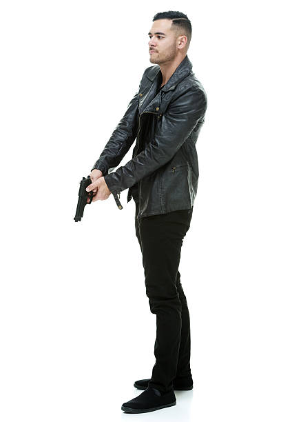 istock Casual man holding gun and looking away 511212644