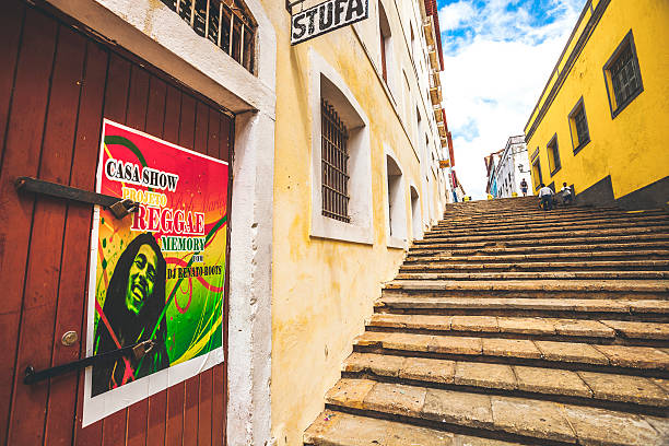 Sao Luis, Brazil - February 4, 2013: A few people walking the street stairs in old town area. To see reggae posters is very common in Sao Luis as it is known also as reggae capital of Brazil.