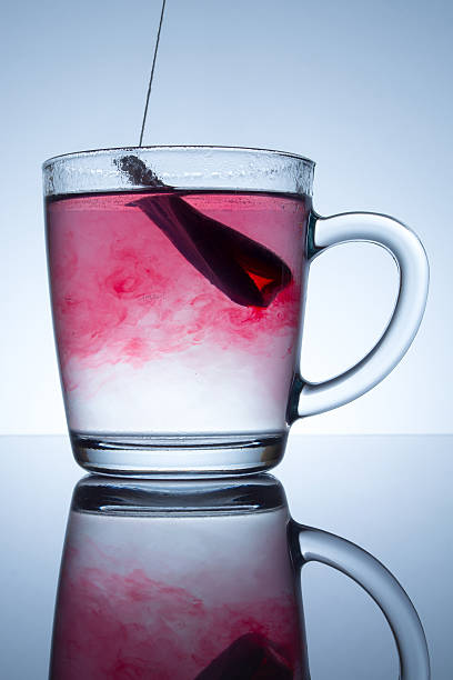 istock tea bag in a transparent mug with beautiful abstract stains 511213862