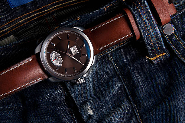 istock Wrist watches as belt on blue jeans 511214324