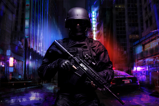 Spec ops police officer SWAT in black uniform on the street