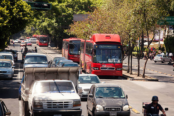 Mexico City, Mexico- May 30, 2012: View of a row of Line 1 Metrobuses  heading to Caminero at a the Insurgentes Avenue. Insurgentes is considered the longest avenue in the world.