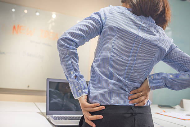 istock Woman doing some simple exercise for her back at office 511219006