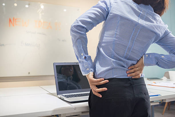 istock Back pain due to long time sitting at working desk 511219036