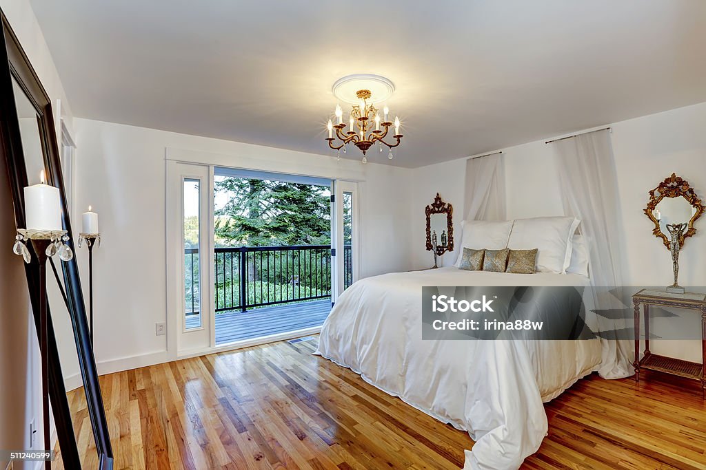 White bedroom interior with walkout deck Refreshing white bedroom with beautiful bed and walkout deck Apartment Stock Photo