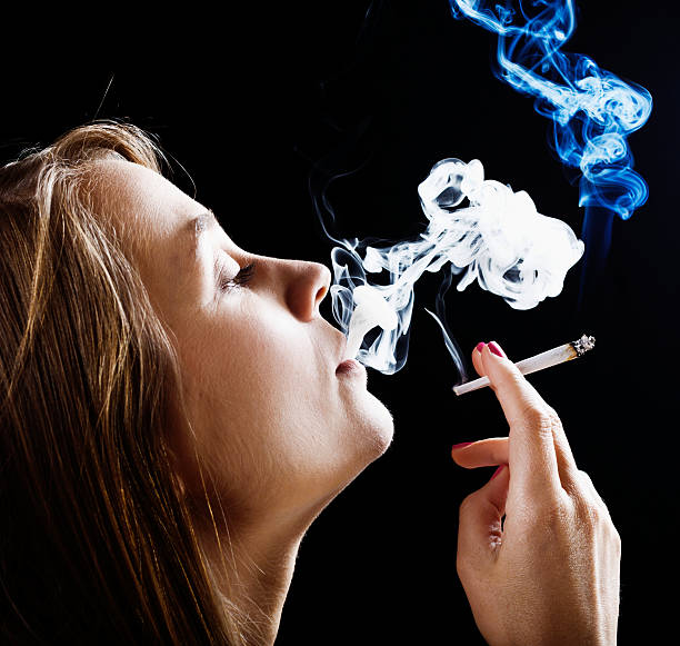 istock Blonde beauty dreamily smoking a marijuana joint 511244631