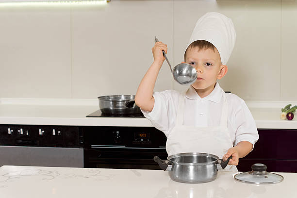 istock Little boy chef tasting his recipe 511244749