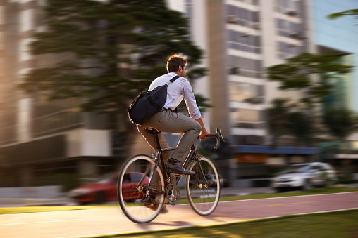 Shot of an attractive young man on his morning bicycle commute to work