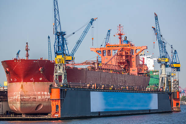 Vessel in Drydock at Hamburg Port-Germany Huge ocean vessel with bulbous bow in a drydock at Hamburg port.  dry dock stock pictures, royalty-free photos & images