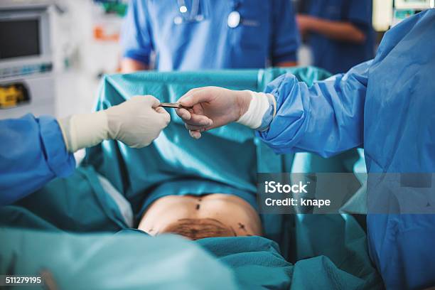 Doctor Doing Surgery Stock Photo - Download Image Now - Adult, Adults Only, Candid